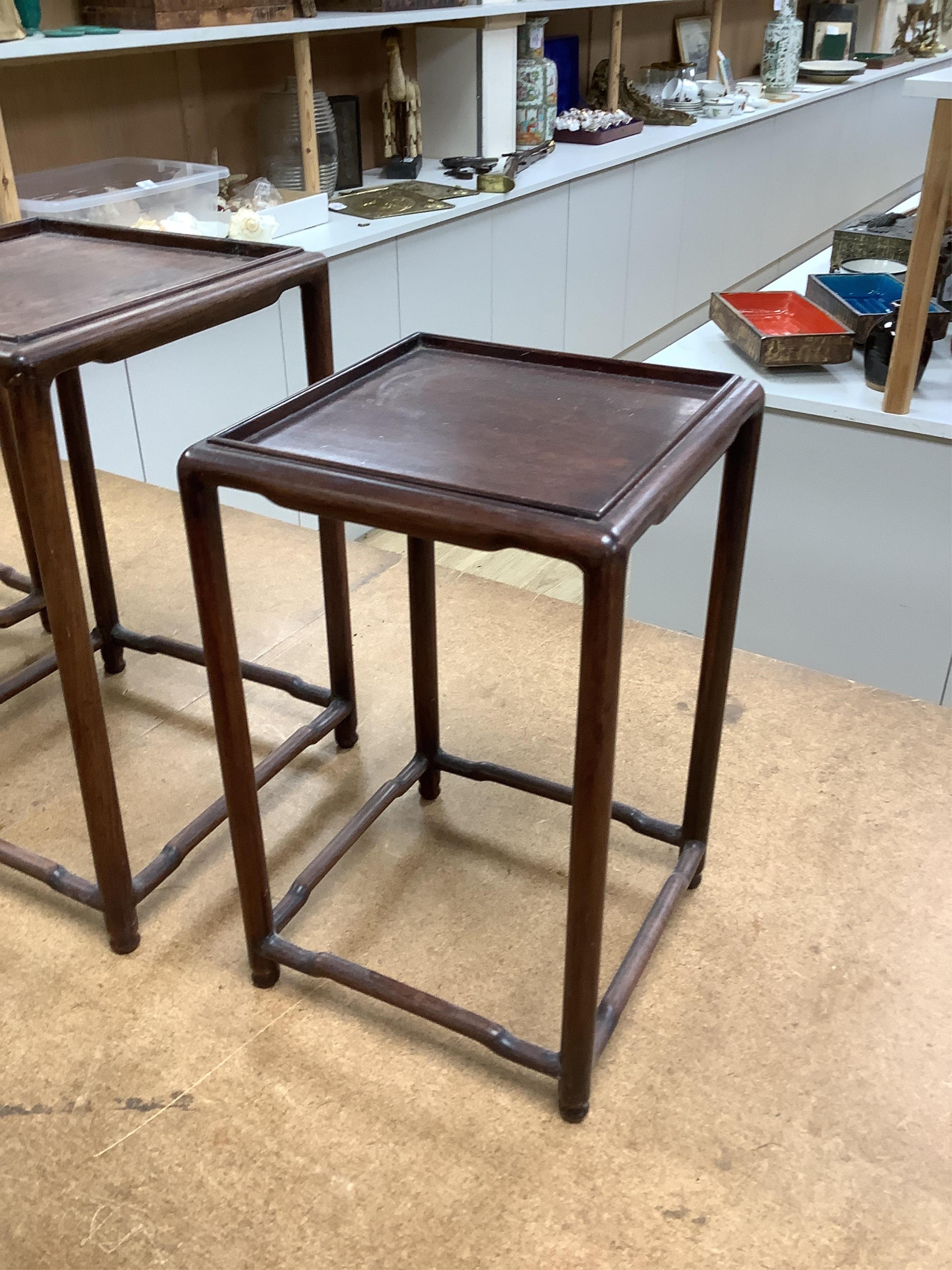 A nest of five Chinese hardwood stands, tallest (largest) 32cm high